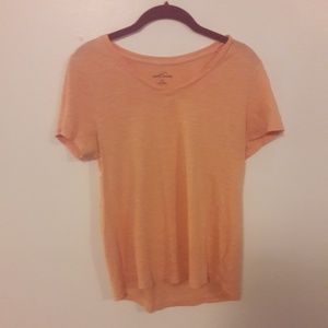 Peachy colored short sleeved t shirt